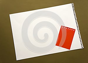 Blank sheet of paper space for design and lettering on a beautiful craft background red notepad sheet. Perforated sheet torn from