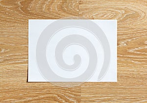 Blank sheet of paper on wooden background