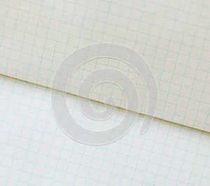 Blank sheets of square and lined paper from a block on a gray background