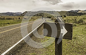 Blank sign with arrow head along the country road