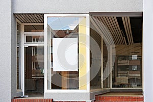 Blank sign in empty store window