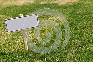 Blank sign on green grass