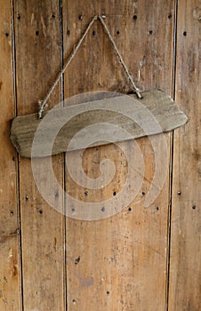 Blank sign hanging from a nail on an old rustic wooden oak wea