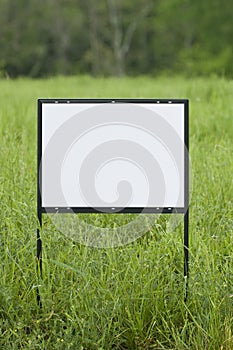 Blank Sign In Overgrown Field Vertical