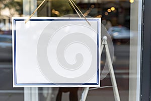 A blank sign in a shop window. Copy space for text