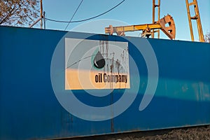 Blank sign from unknown oil company that is splattered with oil and dripping from its surface. Symbol of soiling