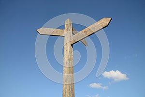 Blank signpost with blue sky and clouds