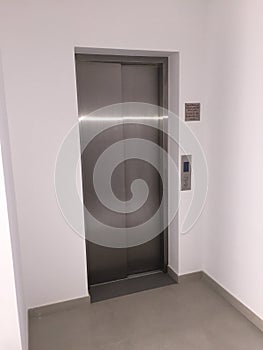 Blank Silver Lift in home Interior. Side View. Empty Lift with buttons close to it. Elevator Interior