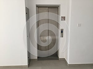 Blank Silver Lift in home Interior. Side View. Empty Lift with buttons close to it. Elevator Interior