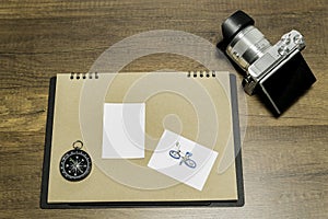 Blank small white paper on brown sheet with Camera and Compass