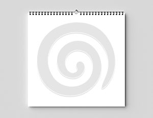 Blank spiral binding wall calendar mock up on dry wall. 3D illus