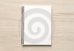 Blank spiral bound notepad mockup template on wood background