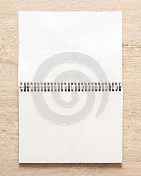 Blank spiral bound notepad mockup template on wood background