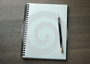 Blank spiral notebook and pencil