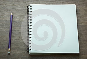 Blank spiral notebook and pencil