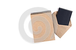 Blank spiral notepads and a recycled envelope