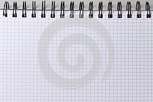 Blank squared sheet of exercise book with wire spiral binding