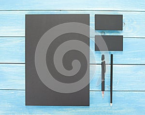 Blank Stationery on wooden background. Consist of Business cards, A4 letterheads, pen and pencil.