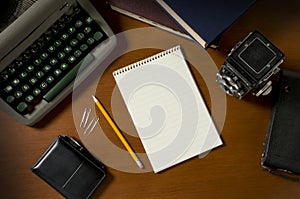 Blank steno notepad on a desk among vintage journalism props