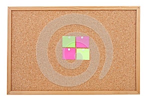 Blank sticky notes pinned on cork memo board