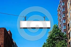 Blank street sign hanging over an avenue.