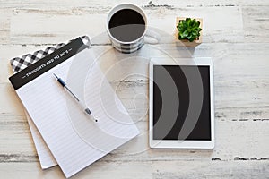 Blank tablet and notepad on modern desktop
