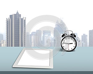 Blank tablet with retro alarm clock on desk