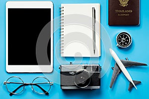 Blank tablet screen with blogger travel objects