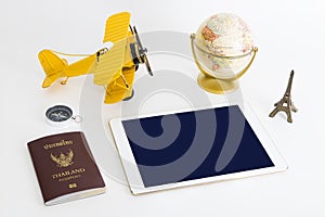 Blank tablet screen with travel objects on white background
