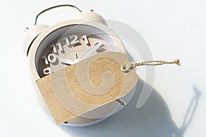 Blank tag mock up on beige alarm clock