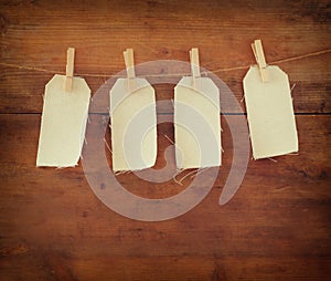 Blank tags hanging on wooden background