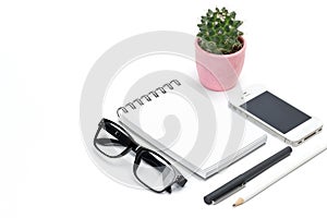 Blank template spiral white notebook notepad, cactus in pot, eye glasses, pencil, smartphone isolated white background