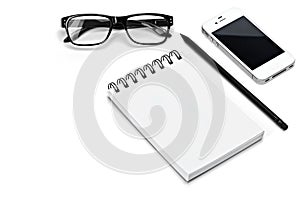 Blank template spiral white notebook notepad, glasses, pencil, smartphone isolated white background