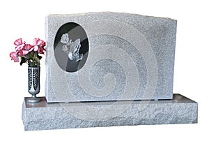 Blank Tombstone Grave Marker Isolated With Flowers photo