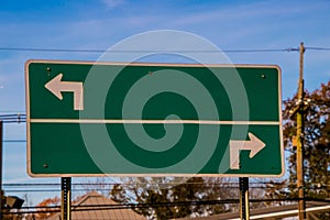Blank traffic sign with arrows pointing in opposite directions photo