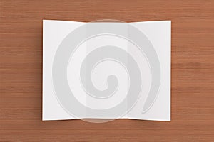 Blank tri fold brochure on wooden background