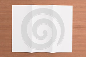 Blank tri fold brochure on wooden background