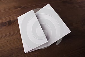 Blank tri fold brochure on wooden background to replace your design or message