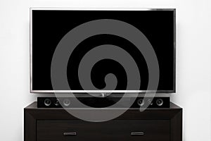 Blank tv with stereo system on brown commode