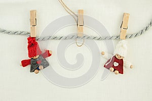 Blank, valentine, greeting card. Wooden pins, knitted loving couple man and woman hanging on a clothesline. On the cloth