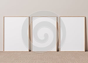 Blank vertical poster frame mock up standing on beige floor. photo