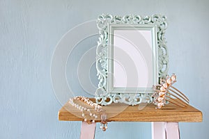 Blank victorian style frame, white pearls necklace and hair comb