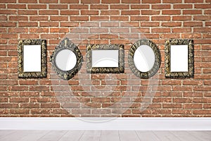 Blank vintage frames hanging on brick wall. Mockup for design