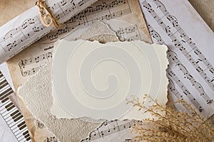 Blank vintage paper card on aged music notes background. Empty grunge postcard with copy space