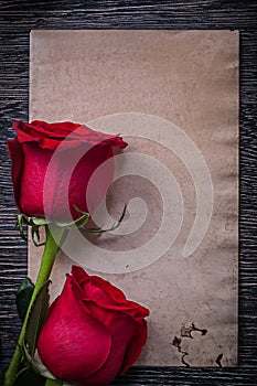 Blank vintage paper red expanded roses on wooden