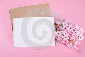 Blank wedding invitation stationery card mockup with envelope on pink background with hyacinth flowers