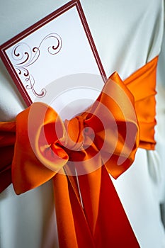 Blank wedding invitation tied with a red bow
