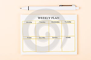 The Blank weekly plan notice block on yellow colour background. Empty schedule and a pen