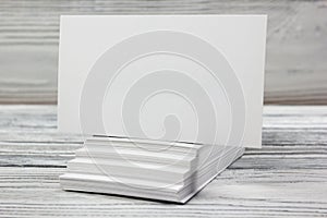 Blank white business cards on wood background