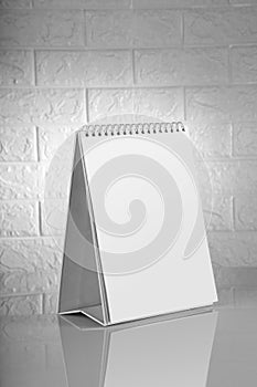 Blank White Calendar for Mockups on Brick Wall Background